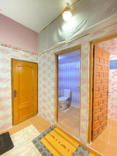 a bathroom being remodeled with a door and a toilet at Guest House Abde Rrahim Baallal in Skoura