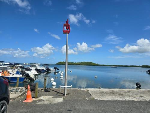 a view of a body of water with boats at Appartement Le Milano in Morne-à-lʼEau