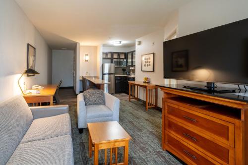 a living room with a couch and a flat screen tv at Staybridge Suites Houston West - Energy Corridor by IHG in Houston
