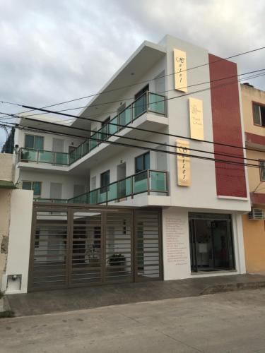 a building with wooden doors in front of it at Quinta Santa Anita in Playa del Carmen