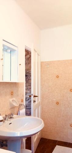 a bathroom with a white tub and a sink at Cascina Del Galin in Lanzo dʼIntelvi