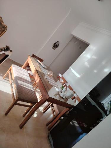 a dining room table with two chairs and a television at Cozy Furnished apartment in new Cairo in Madinaty
