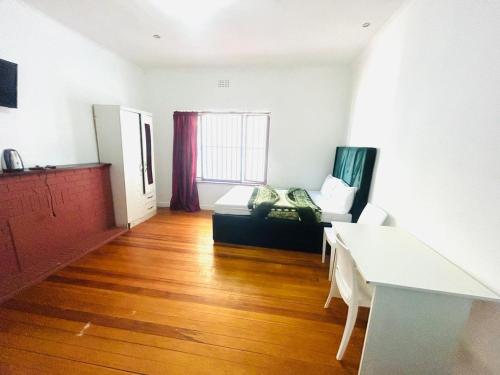 a living room with a couch and a table at Executive Accommodation Bellville 2 in Cape Town