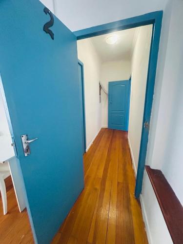 a room with a blue door and a wooden floor at Executive Accommodation Bellville 2 in Cape Town