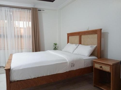 Ένα ή περισσότερα κρεβάτια σε δωμάτιο στο Tembo Homes Riverside Apartments