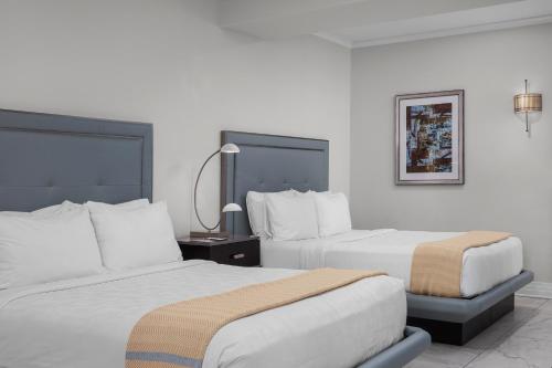 a hotel room with two beds and a lamp at The Jung Hotel and Residences in New Orleans