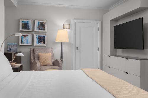 a bedroom with a bed and a tv and a chair at The Jung Hotel and Residences in New Orleans