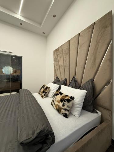 a bedroom with a large bed with two pillows at Luxury Gold apartman in Budapest