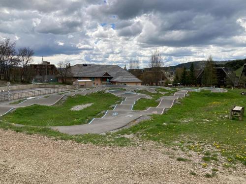 a skate park with winding roads in front of a building at STUDIO 4 COUCHAGES A St JEAN-MONTCLAR ÉTÉ/HIVER in Montclar