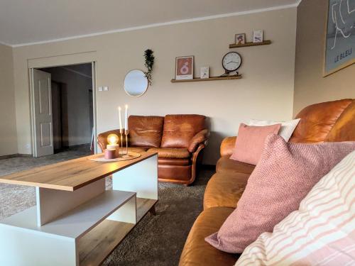 a living room with a couch and a table at SB Apartment with Sauna in Kołobrzeg