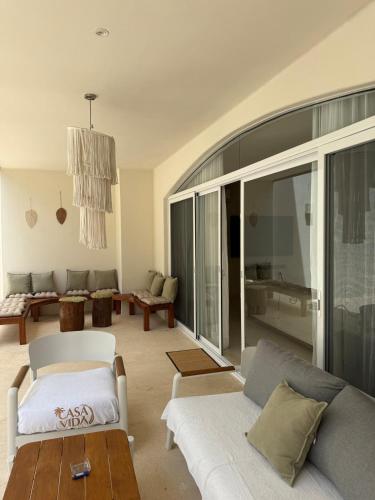 a living room with a couch and a table at Casa Vida Tulum in Tulum