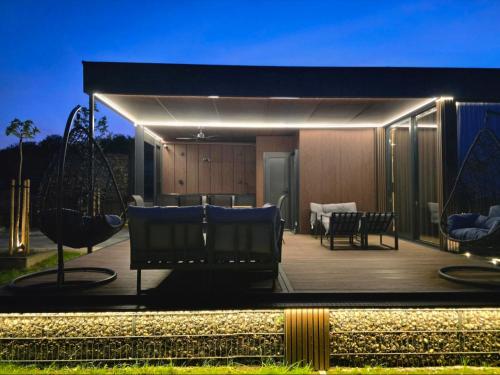 a house with a deck with chairs and lights at Balans house in Petrovaradin