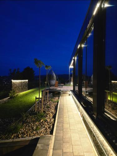 a walkway in front of a building at night at Balans house in Petrovaradin