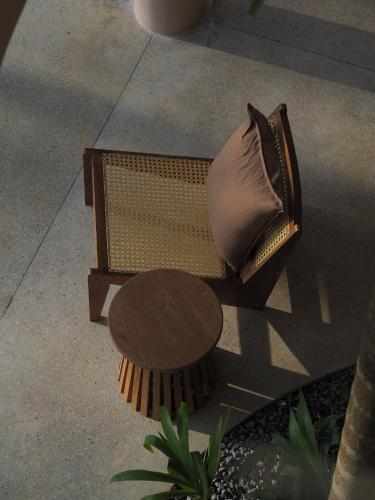 a couch with a pillow sitting next to a table at Sola - Boutique Hotel in Ahangama