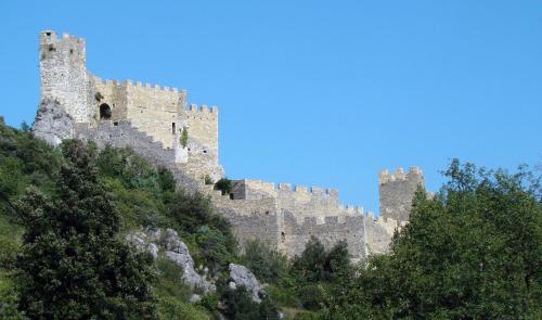 a castle on top of a hill with trees at Maison Les Chênes - Jacuzzi - Calme & Idéalement situé - Clim - Salle de Jeux - Parking in Sauzet