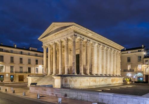 a temple in front of a building at night at Maison Les Chênes - Jacuzzi - Calme & Idéalement situé - Clim - Salle de Jeux - Parking in Sauzet
