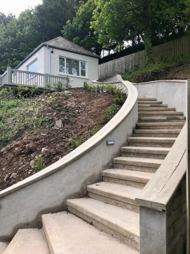 a set of stairs in front of a house at PERIWINKLE COTTAGE, with the most amazing sea view in Youghal