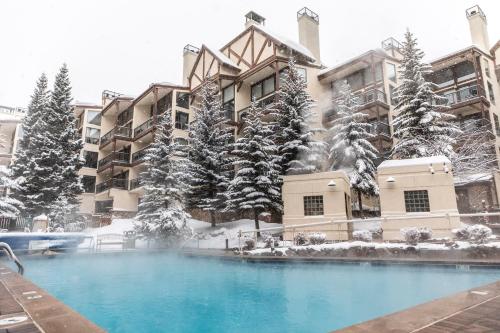 a resort with a swimming pool in the snow at Montaneros in Vail in Vail