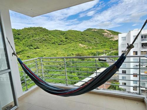 a hammock on a balcony with a view of a mountain at happy summer in Girardot