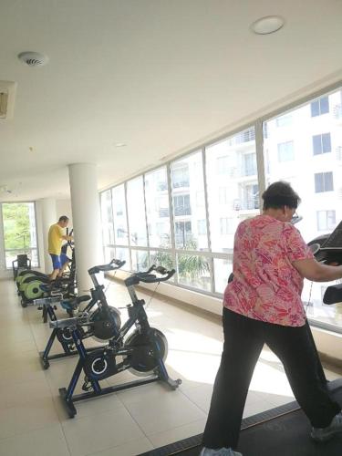a woman standing in a gym with exercise bikes at happy summer in Girardot