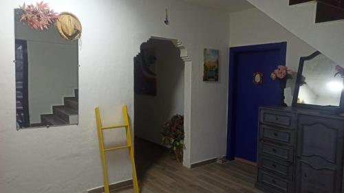 a room with a staircase and a dresser and a blue door at Gölyaka Hotel in Bursa