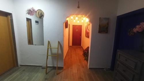 a hallway with a red door with lights on it at Gölyaka Hotel in Bursa