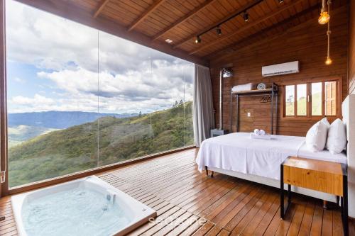Katil atau katil-katil dalam bilik di Cabana na serra com linda vista VST012
