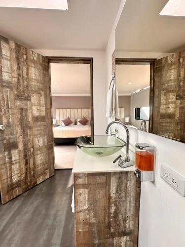 a bathroom with a sink and a mirror at Hotel Agora Boutique in Bogotá