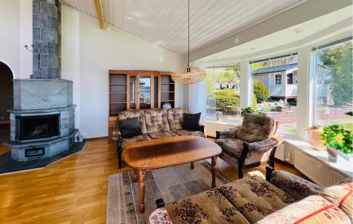 a living room with a couch and a fireplace at 2 Bedroom Lovely Home In Uddevalla in Uddevalla