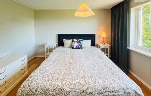 a bedroom with a large bed and a window at 2 Bedroom Lovely Home In Uddevalla in Uddevalla