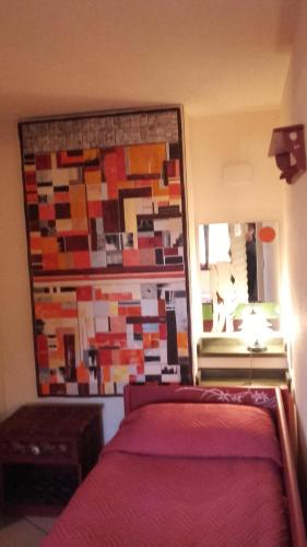 a bedroom with a large mirror behind a bed at L'Antica Cantina in Usini