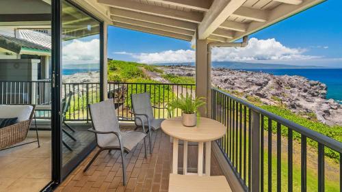 a balcony with a table and chairs and the ocean at Kapalua Bay Villa 30B2 in Kapalua