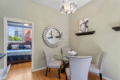 a dining room with a table and chairs and a bedroom at Warehouse District Modern Condo with Private Garage in Raleigh