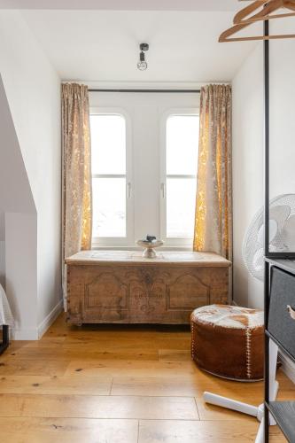 a bathroom with a large tub in a room with two windows at Wohnen wie im Schloss - Alter Bahnhof von Kruft in Kruft