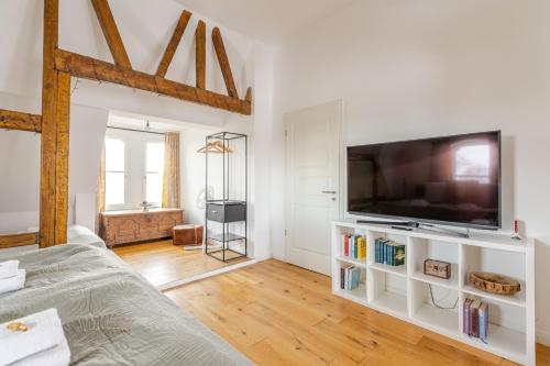 a living room with a large flat screen tv at Wohnen wie im Schloss - Alter Bahnhof von Kruft in Kruft