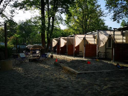 a camp site with a tent and a table and chairs at Skorzęcin Przytulny Zakątek in Skorzęcin