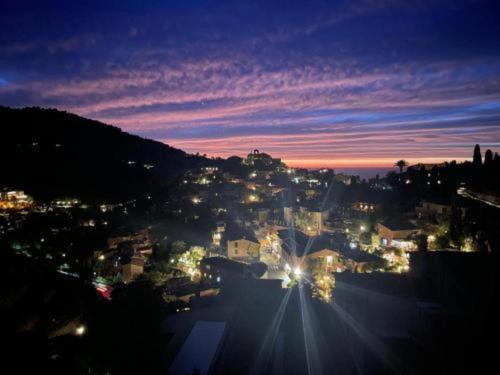 a view of a city at night with lights at Townhouse in Deia with Sea and Mountain Views in Deia
