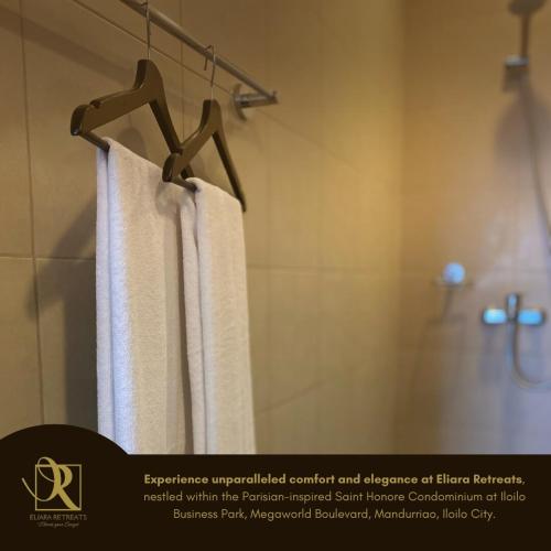 ein Bad mit einer Dusche und weißen Handtüchern in der Unterkunft Luxury Condo in Iloilo City by Eliara Retreats in Iloilo City