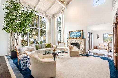 a living room with white furniture and a fireplace at Heavenly Carmel - Stay for 10 in Carmel