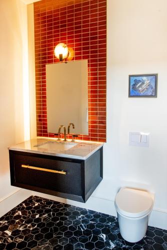 a bathroom with a sink and a toilet at The Bell Athens by Kasa in Athens
