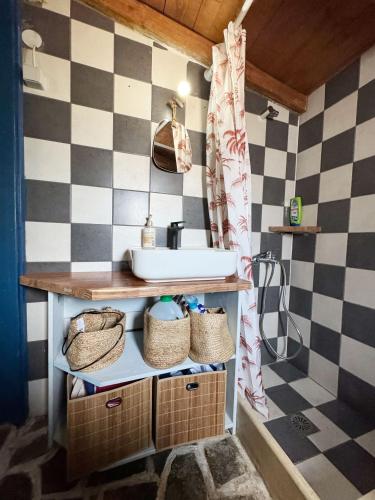 a bathroom with a sink and a counter with baskets at Happynest Leni, Stone House in Dhernikaíika