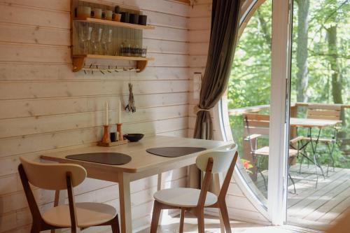 a kitchen with a table and chairs and a porch at Kisvacok tiny house in Kismaros