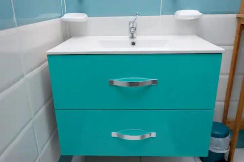 a blue cabinet with a sink in a bathroom at Appartement Le Milano in Morne-à-lʼEau