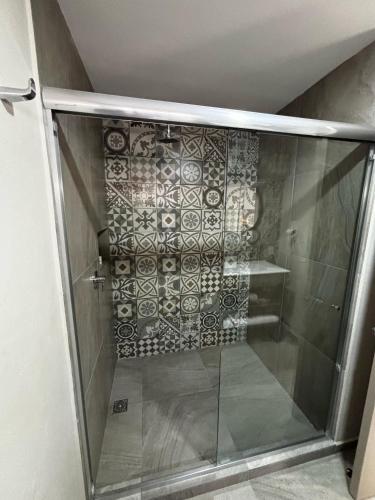 a shower with a glass door in a bathroom at VILLAS EL ENCANTO in Jalpan