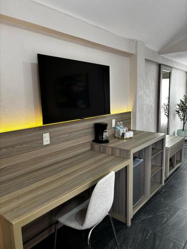 a living room with a television on a wall at VILLAS EL ENCANTO in Jalpan