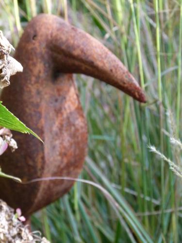 a large rusty object in the grass at Pension Hauenstein in Lagundo