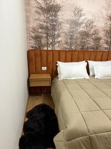 a bedroom with two beds and a dog laying on the floor at 3Mozaiket Sweet Home in Voskopojë