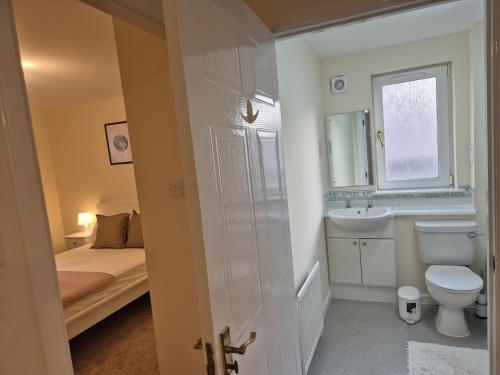 a small bathroom with a toilet and a sink at Spacious Modern 2-BR Apartment in Aberdeen City Centre in Aberdeen