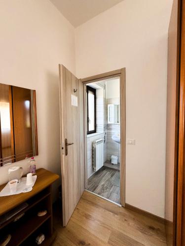 a bathroom with a sink and a mirror and a toilet at Malpensa Bed & Breakfast-No Breakfast in Case Nuove