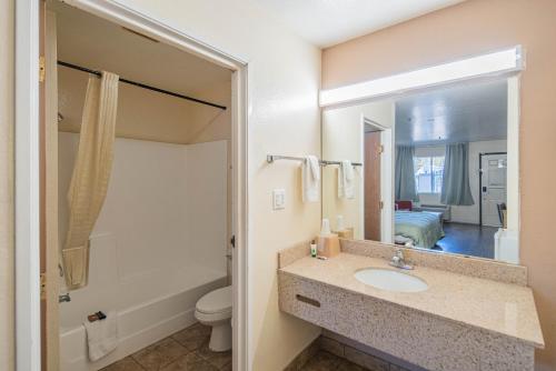 a bathroom with a sink and a tub and a toilet at Hotel Rising in Phoenix